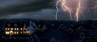 Houses during a lightning storm at night